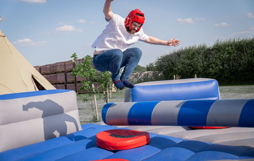 Man jumping over sweeper arm