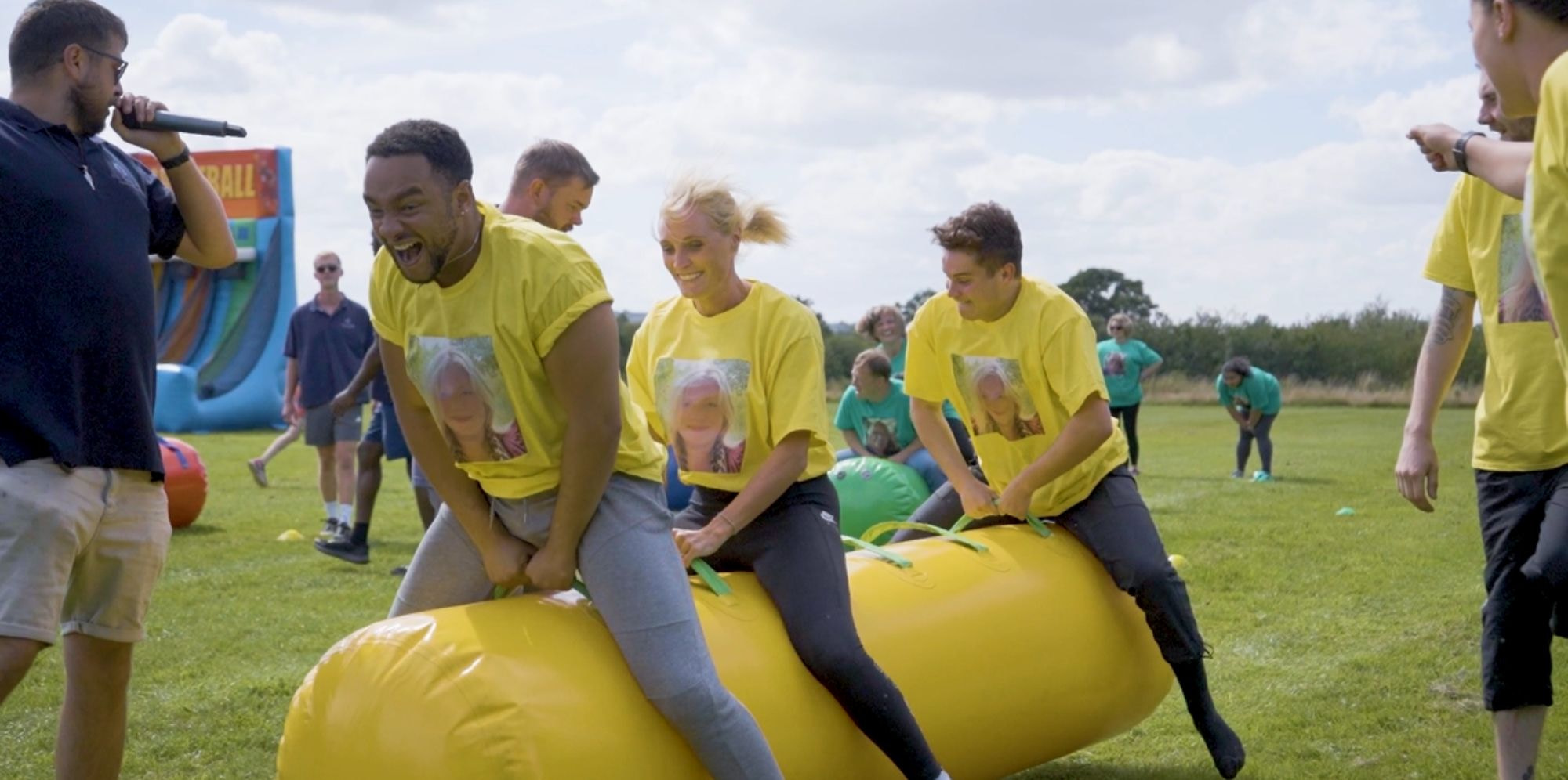 Team having fun on inflatable sausages